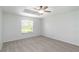 Bright bedroom featuring a ceiling fan, neutral carpet, and a large window offering natural light at 2199 Palm Ct, North Port, FL 34287