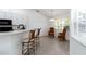 A bright breakfast nook features a window and neutral tile floors at 2199 Palm Ct, North Port, FL 34287