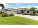 Well maintained single-story home with landscaped lawn, two-car garage, and inviting front door at 2199 Palm Ct, North Port, FL 34287
