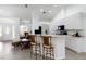 Modern kitchen features an island with seating, white cabinets, and an open design that connects to the living area at 2199 Palm Ct, North Port, FL 34287