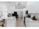 Bright kitchen features white cabinetry, black appliances, breakfast bar, and neutral tile flooring at 2199 Palm Ct, North Port, FL 34287