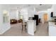 Open concept kitchen features an island with barstool seating, black appliances, and seamlessly connects with the living area at 2199 Palm Ct, North Port, FL 34287