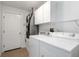 Functional laundry area with modern appliances, storage cabinets, and access door at 2199 Palm Ct, North Port, FL 34287