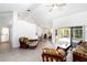 Bright living room featuring tile flooring, vaulted ceilings, and sliding glass doors to the outdoor area at 2199 Palm Ct, North Port, FL 34287