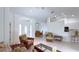 A sunny living room showcases tile floors and open layout to the home's entry, dining, and kitchen at 2199 Palm Ct, North Port, FL 34287