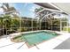 Inviting screened pool surrounded by lush greenery, offering privacy and a serene atmosphere at 2199 Palm Ct, North Port, FL 34287