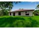 Expansive backyard of the home has a lush green lawn and beautiful tree surround at 23367 Mayville Ave, Punta Gorda, FL 33980