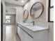 Bright bathroom with double vanity sinks, sleek cabinets, and modern fixtures at 23367 Mayville Ave, Punta Gorda, FL 33980