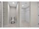 Modern bathroom features white fixtures, including toilet and built-in shelving and walk-in closet at 23367 Mayville Ave, Punta Gorda, FL 33980