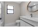 Bright bathroom featuring a white vanity with marble countertop, stylish mirror, and walk-in shower at 23367 Mayville Ave, Punta Gorda, FL 33980