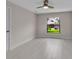 Bright bedroom featuring a ceiling fan, neutral walls, and a large window at 23367 Mayville Ave, Punta Gorda, FL 33980