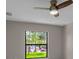 Bright bedroom with a ceiling fan and a large window overlooking the yard at 23367 Mayville Ave, Punta Gorda, FL 33980