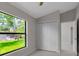 Cozy bedroom featuring a large window and a closet with paneled doors at 23367 Mayville Ave, Punta Gorda, FL 33980
