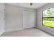Bedroom with white closet and natural light from window at 23367 Mayville Ave, Punta Gorda, FL 33980
