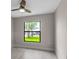 Bedroom with a view of the outdoors from the window and a ceiling fan at 23367 Mayville Ave, Punta Gorda, FL 33980