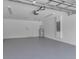 Spacious, clean garage with painted floor, water heater, and door to interior at 23367 Mayville Ave, Punta Gorda, FL 33980