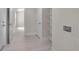 Bright hallway with white doors, a glimpse into another room, and laundry hookups at 23367 Mayville Ave, Punta Gorda, FL 33980