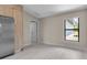 Spacious kitchen with stainless steel refrigerator and a bright window at 23367 Mayville Ave, Punta Gorda, FL 33980