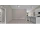 Open living area with white floor and neutral walls at 23367 Mayville Ave, Punta Gorda, FL 33980