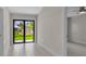 Bright living room featuring tile floors and a sliding glass door to the backyard at 23367 Mayville Ave, Punta Gorda, FL 33980