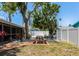 Serene backyard offering a picnic area, mature trees, and a well-maintained privacy fence at 2363 Milford Cir, Sarasota, FL 34239