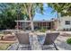 Tranquil backyard with lounge chairs, a picnic table, lush foliage, and a peaceful screened porch view at 2363 Milford Cir, Sarasota, FL 34239