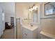 Bathroom featuring a white vanity and mirror with decorative art on the wall at 2363 Milford Cir, Sarasota, FL 34239