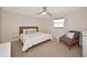 Bedroom with neutral carpet, ceiling fan, natural light, and a sitting chair at 2363 Milford Cir, Sarasota, FL 34239