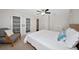 Bedroom with a bed and a decorative chair with glass paneled closet doors at 2363 Milford Cir, Sarasota, FL 34239