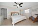 Bedroom with neutral carpet, ceiling fan, natural light, and a sitting chair at 2363 Milford Cir, Sarasota, FL 34239