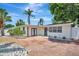 Charming single-story home featuring a well-manicured lawn, tropical landscaping, and an inviting front entry at 2363 Milford Cir, Sarasota, FL 34239