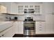 A kitchen with white cabinets, stainless steel appliances, and granite countertops at 2363 Milford Cir, Sarasota, FL 34239