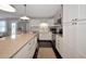 Beautiful white kitchen featuring stainless steel appliances, a center island, and stylish finishes at 2363 Milford Cir, Sarasota, FL 34239