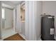 Efficient laundry room featuring a classic water heater and convenient access to a bright, adjacent storage area at 2363 Milford Cir, Sarasota, FL 34239