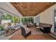Relaxing screened patio featuring cozy furniture, decorative lighting, and a tranquil outdoor space at 2363 Milford Cir, Sarasota, FL 34239