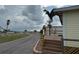 Property with inviting front porch and walkway leading to a scenic community pier nearby at 2601 Gulf N Dr # B4, Bradenton Beach, FL 34217
