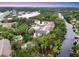 Scenic aerial view of the condo, pool and canal, surrounded by lush greenery and serene waters at 2740 Orchid Oaks Dr # 304, Sarasota, FL 34239