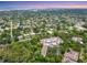 Expansive aerial shot of the condo, showcasing the lush neighborhood and city skyline at 2740 Orchid Oaks Dr # 304, Sarasota, FL 34239