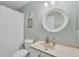 Fresh bathroom features a round mirror, modern vanity, and tub with shower at 2740 Orchid Oaks Dr # 304, Sarasota, FL 34239
