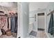 Large closet with shelving and clothing, leading to bright vanity with mermaid decor at 2740 Orchid Oaks Dr # 304, Sarasota, FL 34239