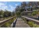 Community dock showcases a gazebo overlooking the calm water and lush vegetation at 2740 Orchid Oaks Dr # 304, Sarasota, FL 34239