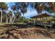 Community gazebo showcases a seating area nestled within trees, perfect for relaxing and enjoying nature at 2740 Orchid Oaks Dr # 304, Sarasota, FL 34239