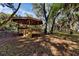 Covered gazebo in a wooded outdoor area offering a serene, shaded space for relaxation and enjoying nature at 2740 Orchid Oaks Dr # 304, Sarasota, FL 34239