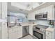 Well-lit kitchen with stainless steel appliances and ample counter space at 2740 Orchid Oaks Dr # 304, Sarasota, FL 34239