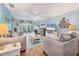 Bright living room featuring hardwood floors, comfortable seating, and serene views at 2740 Orchid Oaks Dr # 304, Sarasota, FL 34239