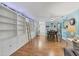 Open-concept living area with built-in bookshelves, wood floors, and a view into the kitchen at 2740 Orchid Oaks Dr # 304, Sarasota, FL 34239