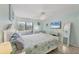 Airy main bedroom features a calming coastal theme, ceiling fan and a view to the outside at 2740 Orchid Oaks Dr # 304, Sarasota, FL 34239