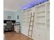 Office space with built-in shelving and a ladder, offering ample storage and style at 2740 Orchid Oaks Dr # 304, Sarasota, FL 34239