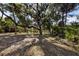 Spacious lot showcasing mature trees creating shade and privacy for a tranquil setting at 2740 Orchid Oaks Dr # 304, Sarasota, FL 34239