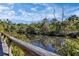 Scenic waterfront view from a wooden boardwalk with vibrant vegetation, adding natural beauty at 2740 Orchid Oaks Dr # 304, Sarasota, FL 34239